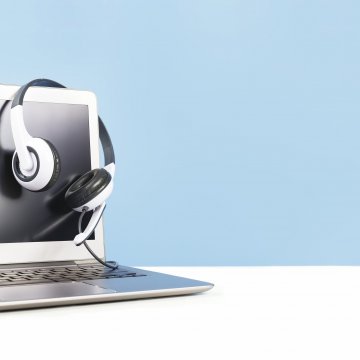 guide voip home set up laptop and headset on monitor blue background